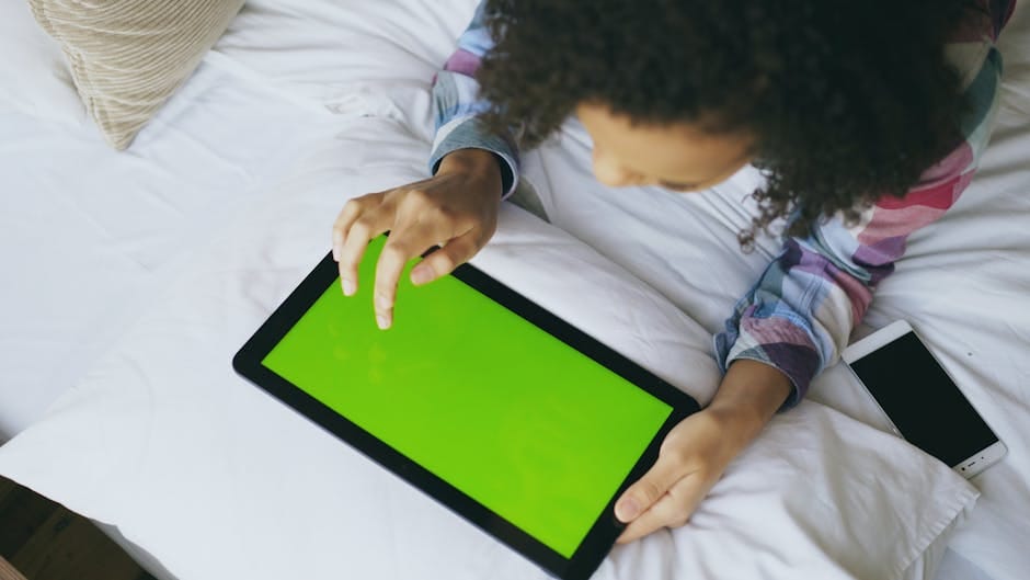Person setting up IPTV subscription USA service on smartphone and tablet simultaneously